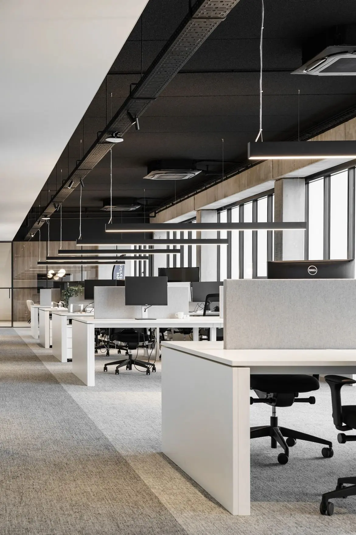 Open-plan office with disconnected desks and monitors